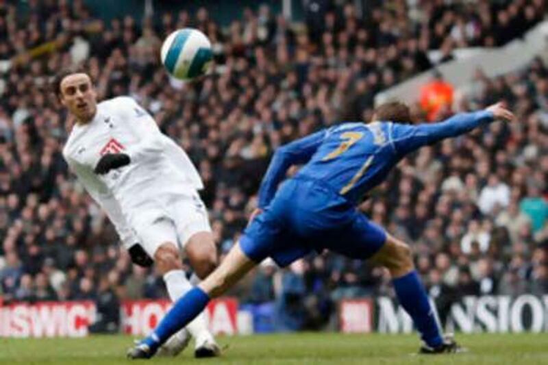 Tottenham Hotspur's Dimitar Berbatov (L) takes a shot at goal past Portsmouth's Hermann Hreidarsson during their English Premier League soccer match at White Hart Lane in London March 22, 2008.     REUTERS/Stephen Hird      (BRITAIN).  NO ONLINE/INTERNET USAGE WITHOUT A LICENCE FROM THE FOOTBALL DATA CO LTD. FOR LICENCE ENQUIRIES PLEASE TELEPHONE ++44 (0) 207 864 9000.

Picture Supplied by Action Images *** Local Caption *** 2008-03-22T134742Z_01_LON901_RTRIDSP_3_SOCCER-ENGLAND-TOTTENHAM-PORTSMOUTH.jpg