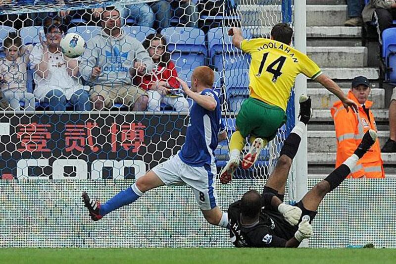 Wes Hoolahan, top, scores past the Wigan Athletic goalkeeper Ali Al Habsi to cancel out an earlier Ben Watson penalty to earn the newly promoted Premier League club a point.

Martin Rickett / AP Photo / PA
