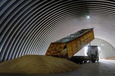 A lorry unloads grain in a granary in the village of Zghurivka, Ukraine. AP