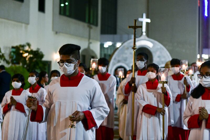 Procession during Christmas Eve midnight mass at St Joseph's Cathedral, Abu Dhabi. Khushnum Bhandari / The National