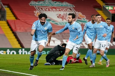 Manchester City's Ilkay Gundogan, left, celebrates after scoring the opening goal during the English Premier League soccer match between Liverpool and Manchester City at Anfield Stadium, Liverpool, England, Sunday, Feb. 7, 2021. (AP photo/Jon Super, Pool)