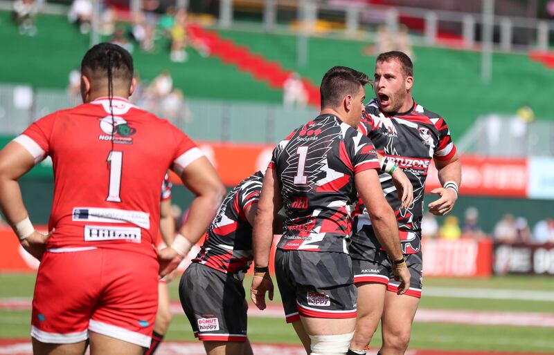 Exiles' Justin Walsh scores a try against Dubai Tigers.