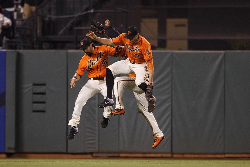 Angel Pagan #16 of the San Francisco Giants, Denard Span #2 and Hunter Pence #8 celebrate after the game against the Miami Marlins at AT&T Park in San Francisco, California. The San Francisco Giants defeated the Miami Marlins 8-1. Jason O Watson / Getty Images / AFP