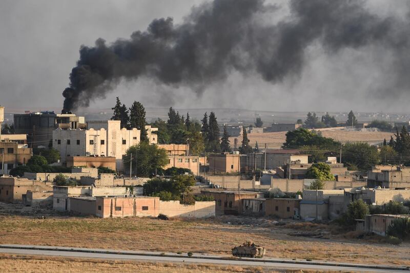 A Turkish army armoured vehicle advances in the Syrian city of Tel Abyad, as seen from the Turkish border town of Akcakale, Turkey. Getty Images