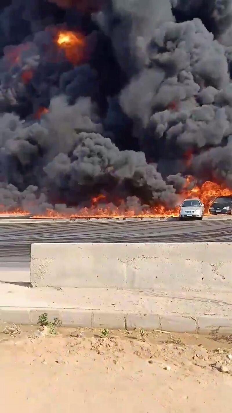 Vehicles are seen in flames from a fire that erupted at the Cairo-Ismailia road, near Cairo, Egypt in this screengrab obtained from a social media video. REUTERS