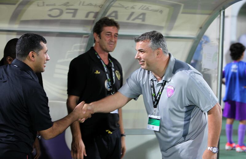 
AL AIN , UNITED ARAB EMIRATES Ð Nov 3 : Cosmin Olaroiu , coach of Al Ain ( right ) meeting with Al Wasl officials before the start of etisalat pro - league football match between Al Ain vs Al Wasl club at Tahnoun Bin Mohammed Stadium in Al Ain. Gilles Morisseau , coach of Al Wasl  ( center ) also seen in the picture. Al Ain won the match by 5-0. ( Pawan Singh / The National ) For Sports.