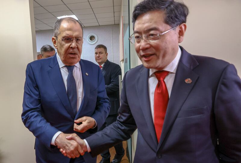 Russian Foreign Minister Sergey Lavrov shakes hands with his Chinese counterpart Qin Gang. EPA