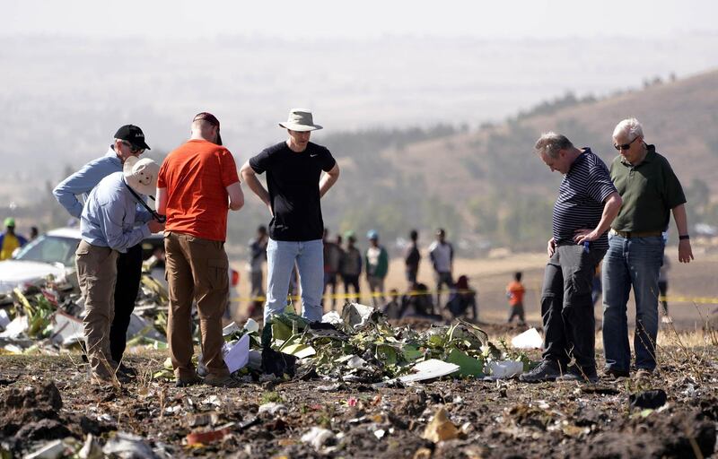 Investigators with the NTSB look over debris at the crash site. Getty Images