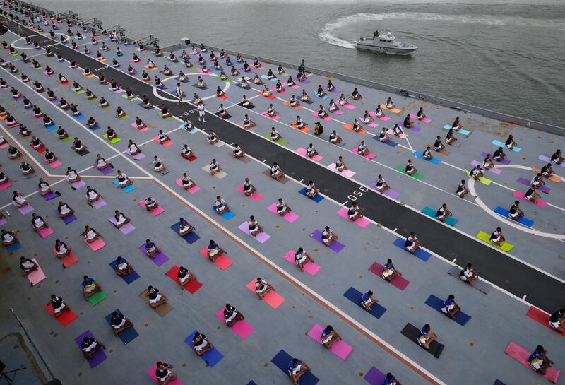 Indian defence personnel perform yoga on the deck of Indian naval aircraft carrier Viraat as they mark International Yoga Day in Mumbai, India. Rafiq Maqbool / AP Photo