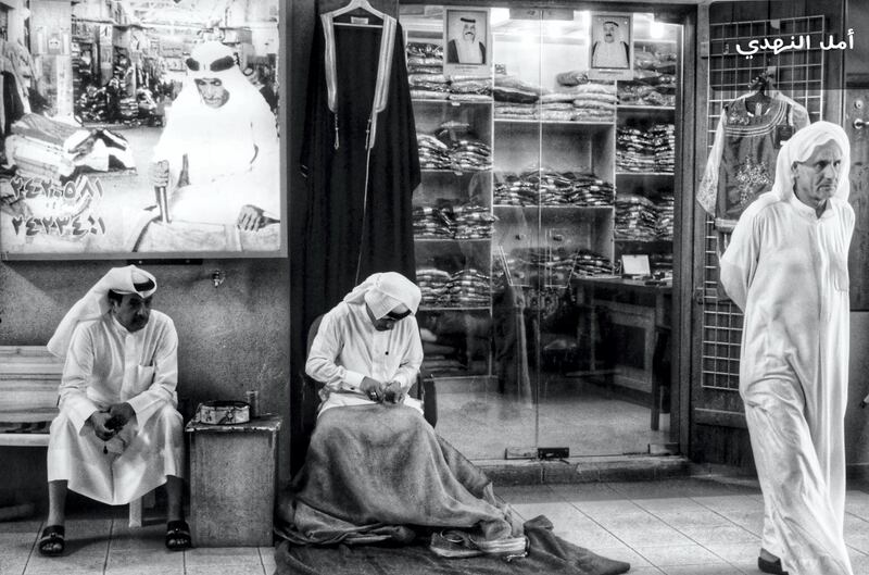 Amal, Kuwait: In the old Mubarakiah souq in Kuwait, Amal captures a traditional clothes shopkeeper and his friends as he opens up shop.