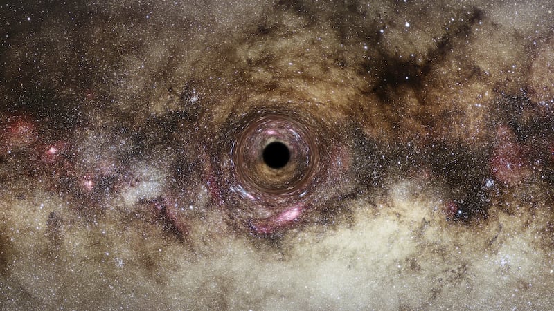 An artist’s impression of a black hole drifting through the Milky Way, after an ultra-massive black hole about 33 billion times the mass of the Sun was discovered by UK astronomers. PA