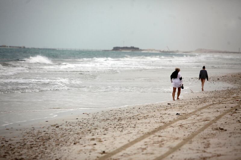 March 21, 2013 (Abu Dhabi) Pedestrians walk along the Saadiyat Public Beach as high winds kick up the surf in Abu Dhabi March 21, 2013. (Sammy Dallal / The National)