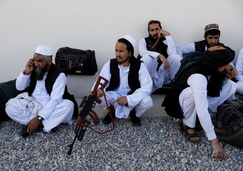Newly freed Taliban prisoners sit with a handmade toy gun at Pul-i-Charkhi prison in Kabul, Afghanistan May 26, 2020. REUTERS/Mohammad Ismail