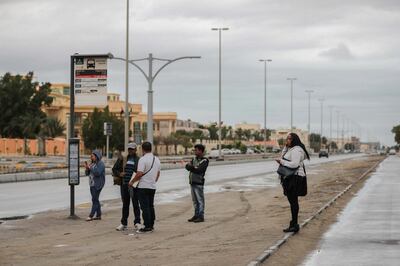 Abu Dhabi, UAE, February 25, 2018.   Commuters well wrapped up for the elements waiting for their bus at 16th Street Khalifa A City, AUH., 
 Victor Besa / The National
