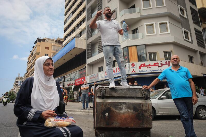 A demonstrator shouts slogans from a road block during an anti-government protest in Beirut, Lebanon. Bloomberg