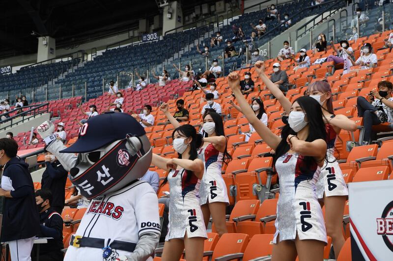 Fans of the Doosan Bears cheer at the Jamsil Baseball Stadium in Seoul. EPA