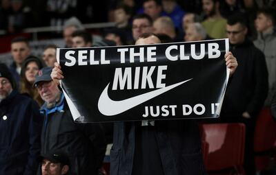 FILE PHOTO: Soccer Football - Premier League - Arsenal v Newcastle United - Emirates Stadium, London, Britain - February 16, 2020   A fan displays a banner in reference to Newcastle United owner Mike Ashley during the match   REUTERS/Eddie Keogh  EDITORIAL USE ONLY. No use with unauthorized audio, video, data, fixture lists, club/league logos or "live" services. Online in-match use limited to 75 images, no video emulation. No use in betting, games or single club/league/player publications.  Please contact your account representative for further details./File Photo