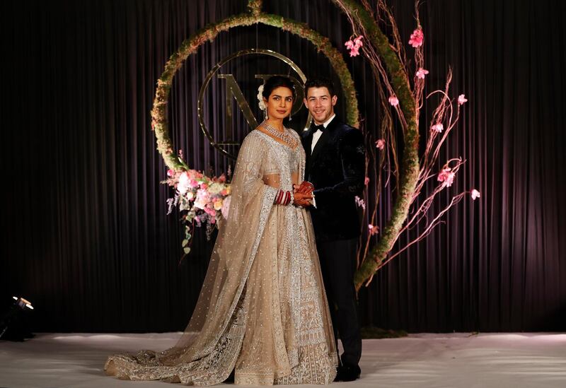 Newlyweds Priyanka Chopra, 36, and Nick Jonas, 26, pose for a photograph during a reception at a hotel in New Delhi on December 4, 2018. Photo: AP