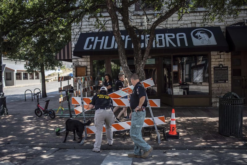An ATF K9 unit surveys the area near the scene of a shooting in Austin, Texas. At least 13 people were taken to hospitals after a shooting happened on Austin's famous 6th Street. The shooter is still at large. AFP