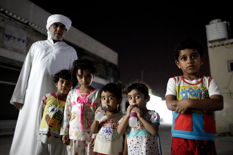 August 15, 2011 (Umm al Quwain) Mohammed Aukbar, 42, left, stands with his two children, Hassen, 3, right, and Hussan, 2, center, along with his nieces Fatima, second from right, and Fatima, 3rd from left, also with his nephew Mohammed, 3, outside his home in the old city of Umm al Quwain from August 15, 2011.  Mohammed originally from Pakistan was born in the UAE and use to work for the police for over 10 years, but was fired 10 years ago after he could not produce a passport. Unable to get a passport from Pakistan he is left in limbo unable to find a good paying job. (Sammy Dallal / The National)