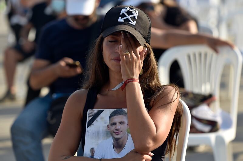 Families and relatives of people killed in the blast carried portraits of their loved ones to the commemoration Mass in Beirut.