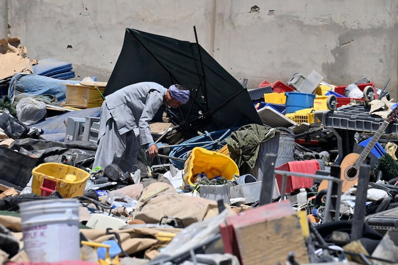 A man selects valuable items at a recycling workshop near the Bagram Air Base. AFP