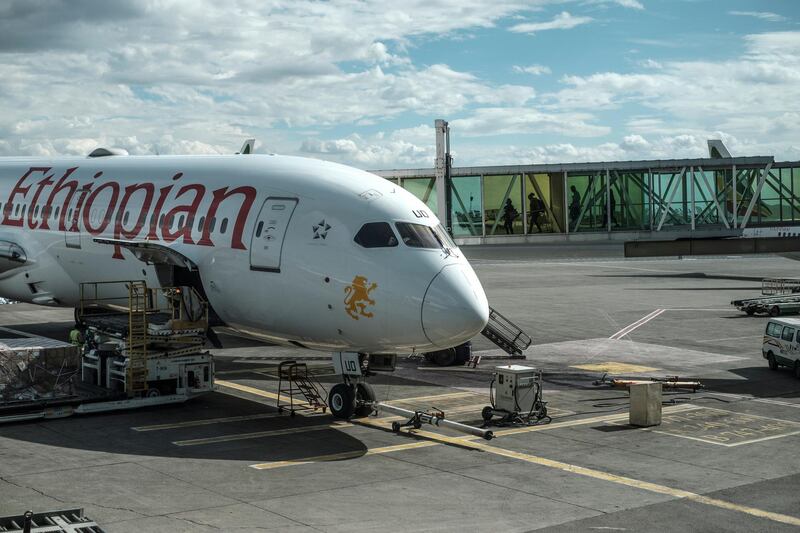 People board an Ethiopian Airlines aeroplane at the Bole International Airport, in Addis Ababa, on March 17, 2020. (Photo by EDUARDO SOTERAS / AFP)