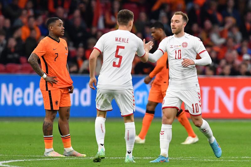 Joakim Maehle congratulates Christian Eriksen following his goal during the match between Netherlands and Denmark. AFP