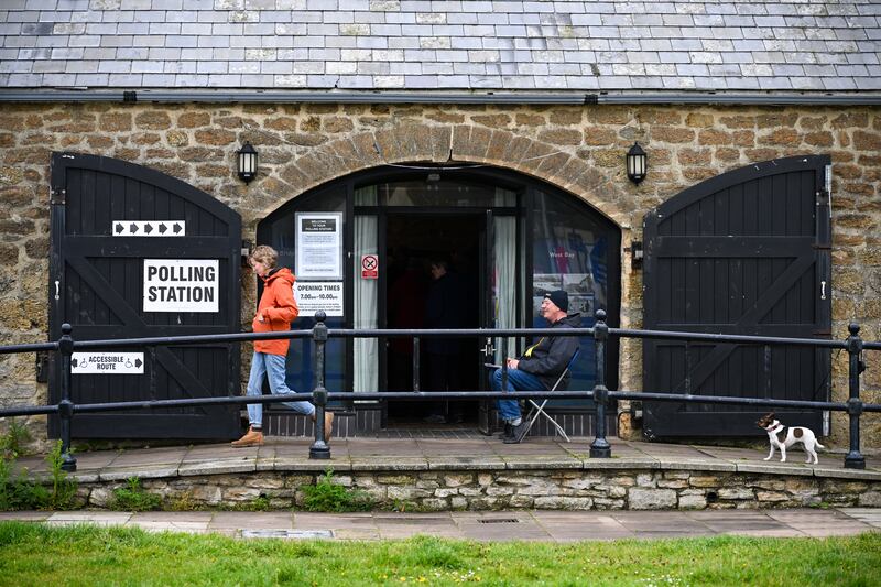 A person leaves the polling station at The Salt House in West Bay. Getty Images