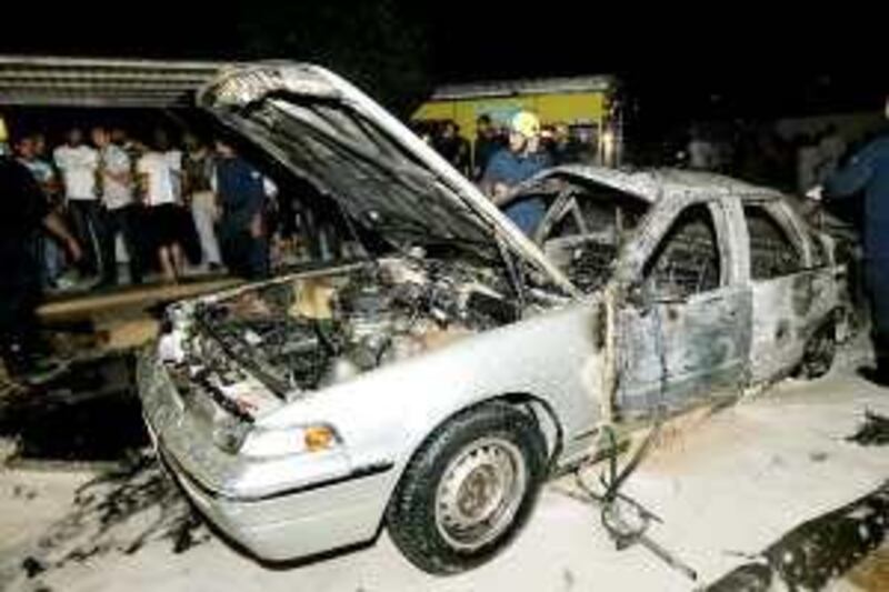 Bahraini firefighters put out the blaze the in the car following the explosion on Thursday night