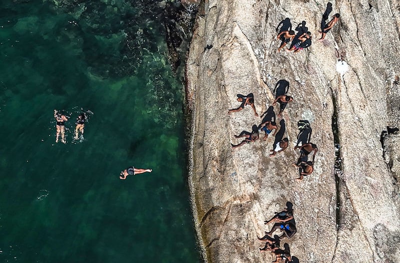 Jumping from a rock at Piratininga beach in Niteroi, Brazil. EPA