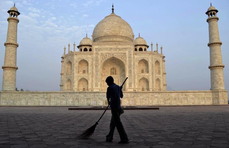 A worker sweeping in front of Taj Mahal in Agra, India. Authorities have been applying 'mud packs' around the side walls and towers since last year to draw the impurities out of the yellowing stone, but have plans to begin the same work on the the main central dome in 2017. Pawan Sharma/AP Photo