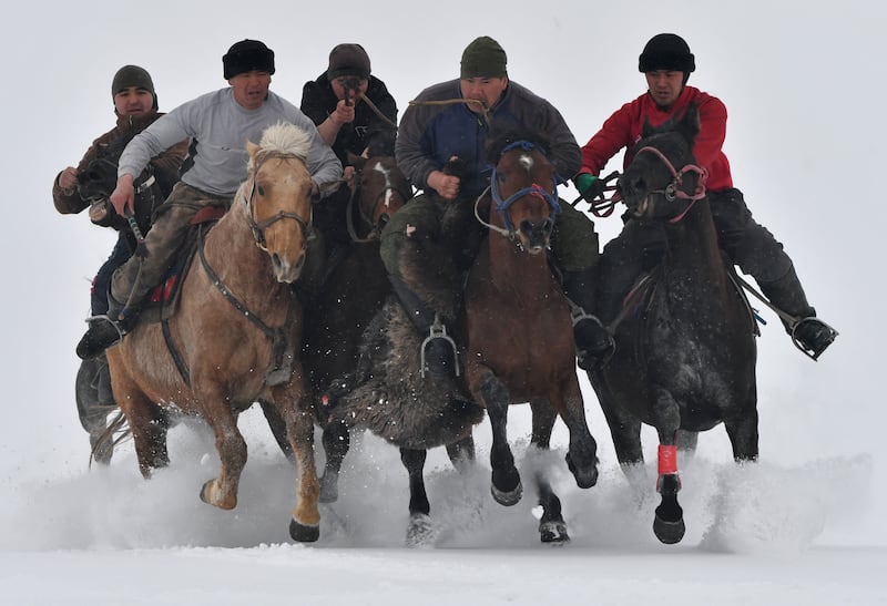 Riders compete in the traditional Central Asian sport of Kok-Boru (Gray Wolf) or Buzkashi (Goat Grabbing) in the village of Uch-Emchek, about 30km from Bishkek. Players compete for points by throwing a stuffed sheepskin into a well.  AFP