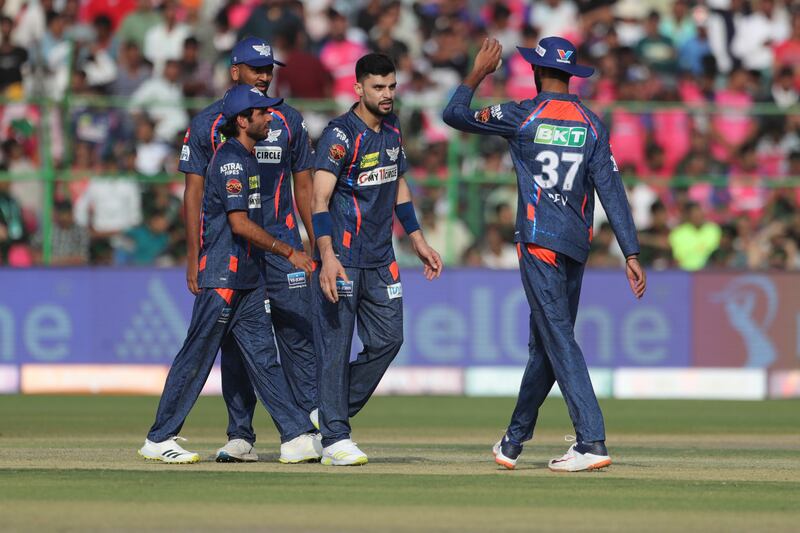 Lucknow Super Giants' Naveen-ul-Haq, without cap, celebrates with teammates after the dismissal of Rajasthan Royals' Riyan Parag. AP 