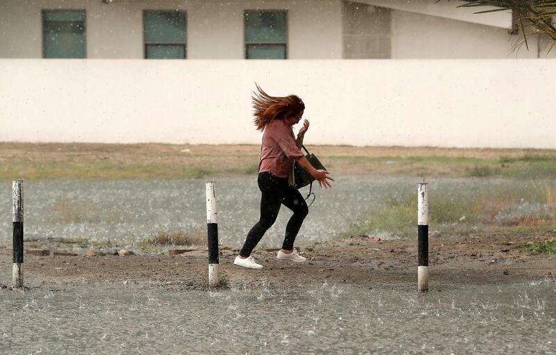 DUBAI, UNITED ARAB EMIRATES , March 22 – 2020 :- One of the commuter caught in the heavy rain in Al Barsha in Dubai. (Pawan Singh / The National) For News/Online/Instagram. 