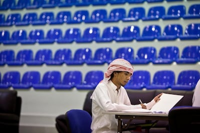 Abu Dhabi, United Arab Emirates, August 5, 2012:  
Seventeen-year-old Omar Khaled Mohammed al Zubairi, who's hoping t become a mechanical engineer, fills out his application and  registration forms during the first day of admissions at the Abu Dhabi Vocational Education and Training Institute on Sunday, August 5, 2012, in Abu Dhabi. (Photo / Silvia Razgova)


