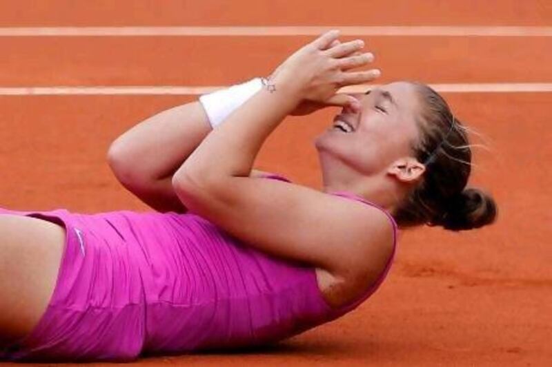 Sara Errani collapses to the clay after winning her women's semi-final match against Samantha Stosur. The Italian will now meet Maria Sharapova for the French Open title.