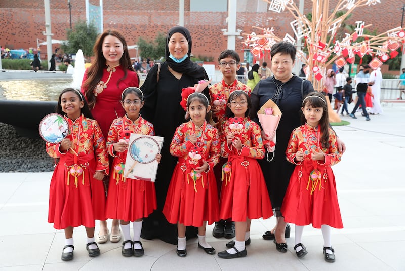 From left, Liting Wang, Reem Hong, principal of Happy Mandarin Chinese Language School, and Dr Liu Yanhui with some of the young performers. Pawan Singh / The National