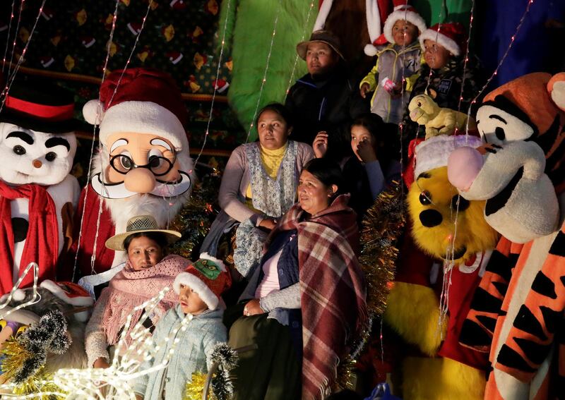 Bolivians pose for a Christmas photo at the San Francisco square in La Paz, Bolivia.REUTERS