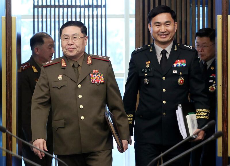 North Korean Lt. Gen. An Ik San, left, and his South Korean counterpart Maj. Gen. Kim Do-gyun enter into meeting room inside the Peace House at the border village of Panmunjom, South Korea. Korea Pool / Yonhap via AP