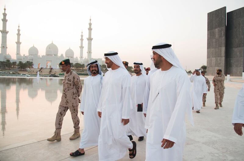 Sheikh Mohammed, speaks with Sheikh Khalifa bin Tahnoon bin Mohammed Al Nahyan (centre L), while visiting the Wahat Al Karama construction site. Seen with Mohammed Al Mazrouei, Undersecretary of the Crown Prince Court of Abu Dhabi (R), Lt Gen Hamad Thani Al Romaithi, Chief of Staff of the Armed Forces (L). Mohamed Al Suwaidi / Crown Prince Court — Abu Dhabi