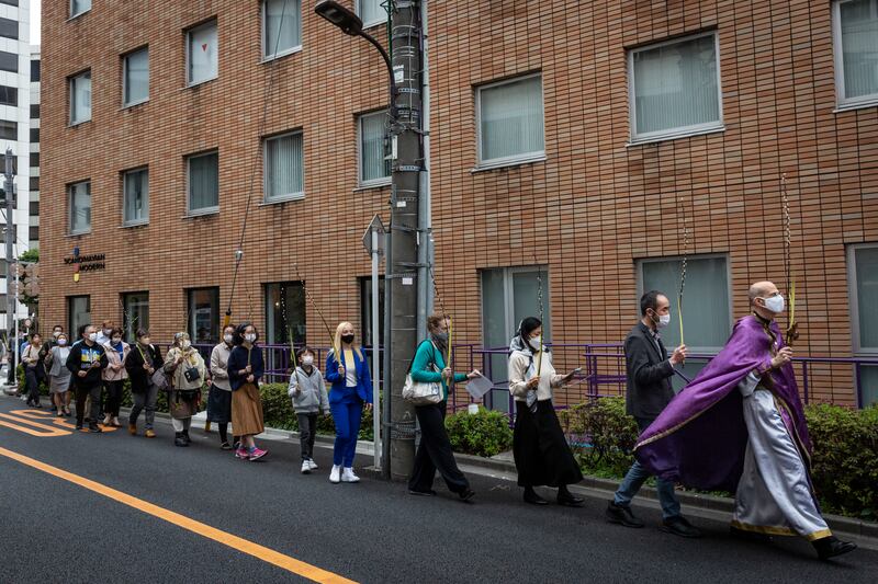 Father Paul Koroluk, of the Orthodox Church of Ukraine in Japan, leads parishioners in a Palm Sunday procession outside Saint Alban's church in Tokyo. Getty Images