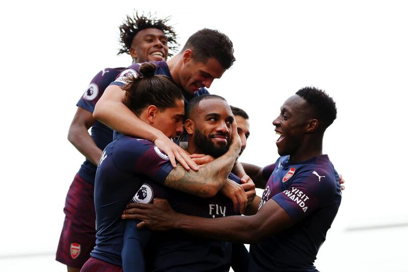 LONDON, ENGLAND - OCTOBER 07:  Alexandre Lacazette of Arsenal celebrates with teammates after scoring his team's second goal during the Premier League match between Fulham FC and Arsenal FC at Craven Cottage on October 7, 2018 in London, United Kingdom.  (Photo by Catherine Ivill/Getty Images) *** BESTPIX ***