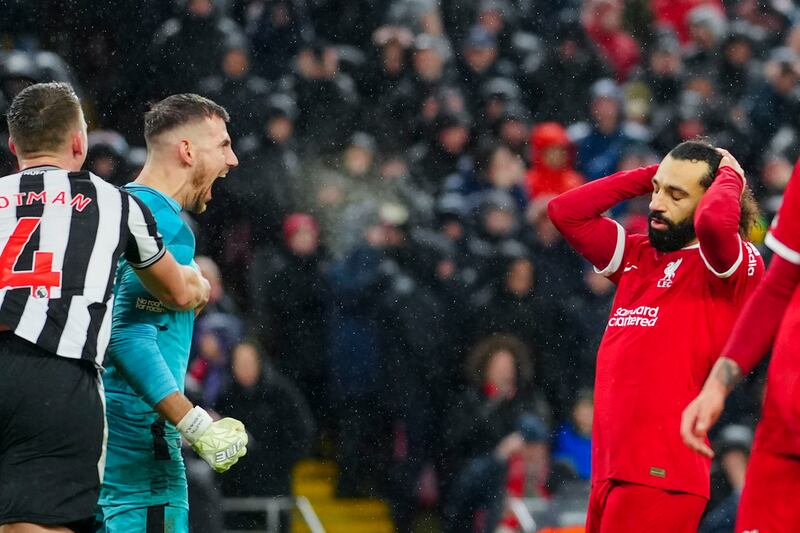 Martin Dubravka celebrates his penalty save in front of a dejected-looking Mohamed Salah. AP