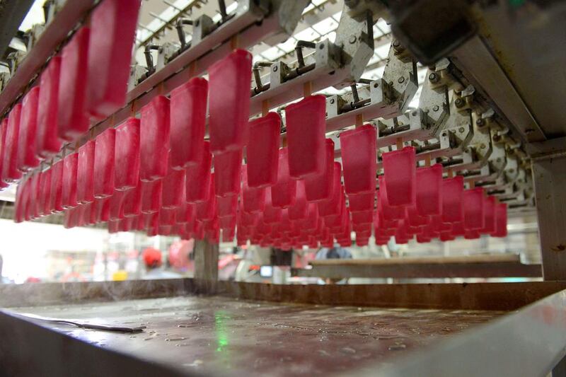 A production line for popsicles are pictured at the Havmor plant at Naroda near Ahmedabad in India. Havmor produces some 200,000 litres of ice cream daily from its two factories during the peak summer season when demand for their products are high. Sam Panthaky / AFP