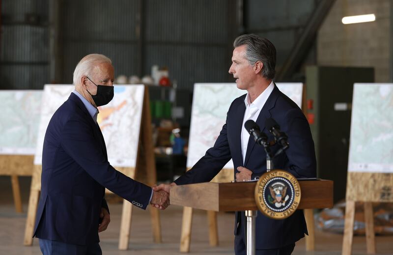 US President Joe Biden shakes hands with California Governor Gavin Newsom after a helicopter tour of the Caldor fire damage in California on September 13, 2021. AFP