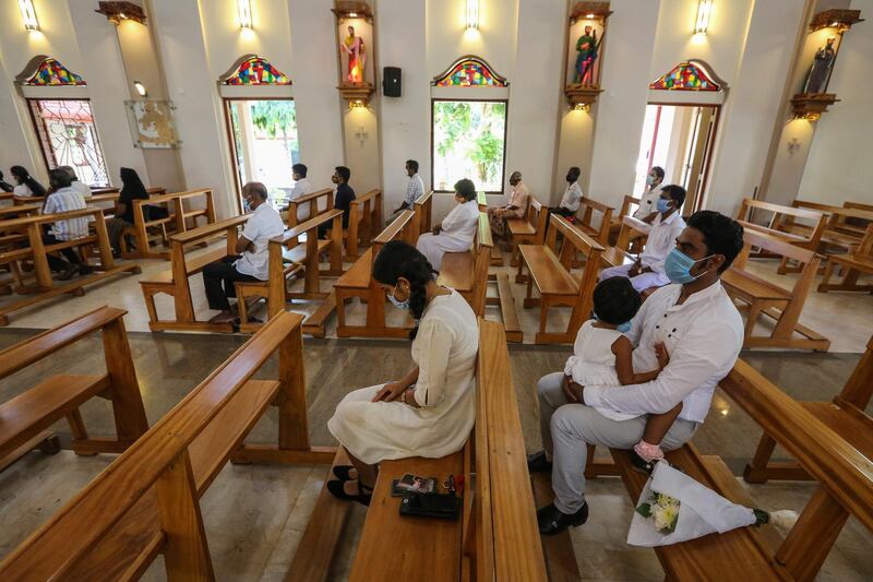 epa08374726 Relatives of an Easter Sunday 2019 suicide bomb attack victim pray on the anniversary of the attack, at the St. Sebastian's church, in Katuwapitiya, Sri Lanka, 21 April 2020. This year the 21 April marks the first anniversary of a terrorist attack that saw three churches and three luxury hotels targeted in Colombo, in series of coordinated suicide bombings. The bombings killed more than 250 people.  EPA/CHAMILA KARUNARATHNE