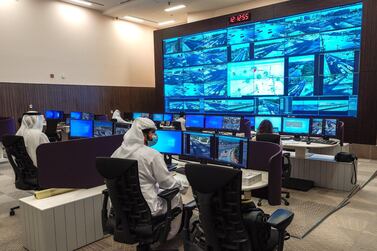 Employees at the control room monitor traffic movement across the emirate. Victor Besa / The National