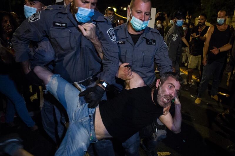Police officers detain a protester during a demonstration in Jerusalem, Israel. Getty Images