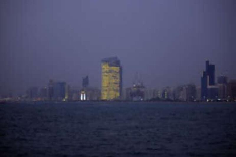 The Abu Dhabi Investment Authorities headquarters dominates the Corniche, burning brightly at night. Solar-powered blinds close during the day to keep the 1,000 employees cool.